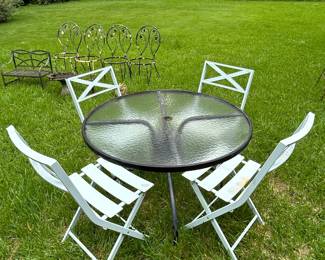 Wrought iron patio set , glass top with 4 chairs 