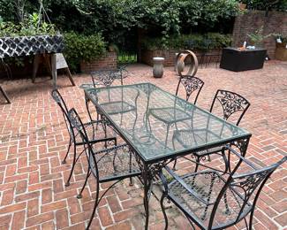 Wrought Iron patio set with glass top and 6 chairs 