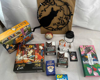 Lot 143: Cat-themed wall art, figurines, and puzzles