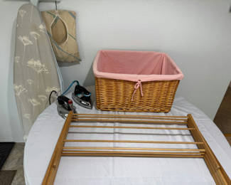 Lot 142: Ironing board with irons, wicker laundry basket, garment bag, and drying rack components