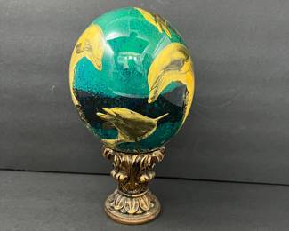 Vibrant Hand-Painted Glass Egg in Blue & Green Ocean Scene with Leaping Dolphins- On a Decorative Pedestal Stand