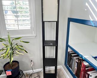 Black modern shelf floor lamp featuring built-in storage tiers and an integrated top fabric light shade.
