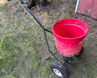 EarthWay EV-N-SPRED spreader features a 50-pound capacity red poly hopper for seed or fertilizer