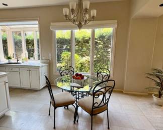Round glass dining set, table top decor and floor plants