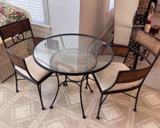 Round glass top table and woven accent chairs