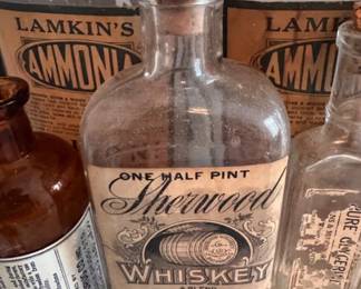 Vintage ammonia and whiskey bottles