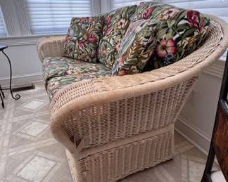 Wicker loveseat with cushions and pillows, matching sofa also in auction