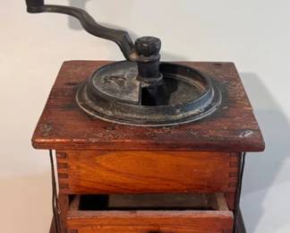Vintage wooden coffee grinder with a cast iron crank handle