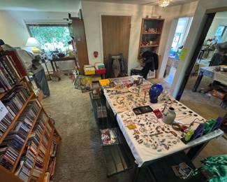 Massive collection of CDs, metal topped farmhouse 6 piece dining room table set, silver and turquoise rings and necklaces, bolo ties, earrings, mint coin sets for every year back to 1970