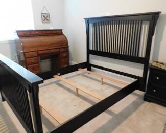 Black Mission-style wooden bed frame features classic vertical slat accents on both the headboard and footboard
