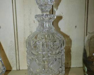 Vintage crystal decanter with intricate diamond-cut patterns and a matching solid glass stopper