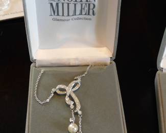 Nolan Miller Glamour Collection lariat necklace featuring a crystal-encrusted bow design and two faux pearl drop pendants