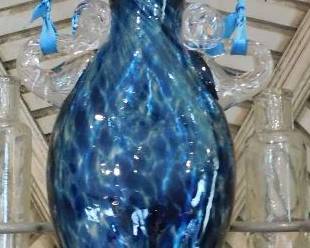 Blue art glass hanging vessel, flared top vase, hangs by cord.