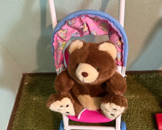 Bear in doll stroller