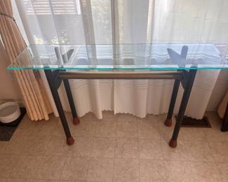 Modern Glass Console Table / Entryway Table – Mid Century Style Price $95 Category Furniture → Tables → Console Tables Description Modern glass console / sofa table with black metal legs and brass accent bar. Tempered glass top with clean modern design. Perfect for an entryway, hallway, behind a couch, or as a plant table. Excellent condition and very sturdy. Approximate size: 48” L × 16–18” W × 30” H
