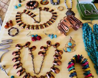 Various mid-century modern copper jewelry pieces.