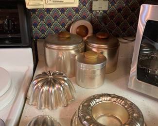 copper canisters, moulds, and under-cabinet can opener