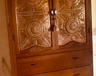 Brass looking punched tin cabinet.