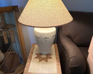 Fluer de Lis White ceramic Lamp with shade (2). Sitting on a trunk with lift top
