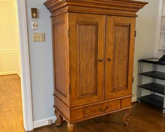 R25 - $60. Entertainment Armoire in Excellent Condition. Has outlets inside. Measures 46" x 26" x 67" tall.