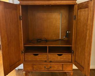 R25 - $60. Entertainment Armoire in Excellent Condition. Has outlets inside. Measures 46" x 26" x 67" tall.