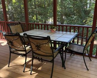 R4 - $225. Garden Treasures Classic Patio Set. Excellent Condition. Table with 4 arm chairs. Metal base with removable tile top. Has been used on a covered screened in porch. Table measures 63" x 39" x 28" tall.