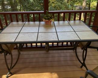 R4 - $225. Garden Treasures Classic Patio Set. Excellent Condition. Table with 4 arm chairs. Metal base with removable tile top. Has been used on a covered screened in porch. Table measures 63" x 39" x 28" tall.