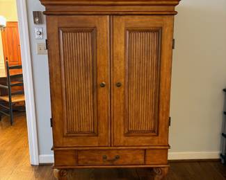 R25 - $60. Entertainment Armoire in Excellent Condition. Has outlets inside. Measures 46" x 26" x 67" tall.