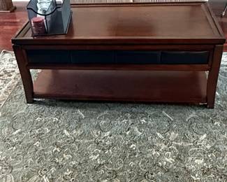 Dark Wood Coffee Table with Upholstered Panels and Lower Shelf