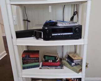 White 4-Tier Plastic Shelving Unit with Assorted Electronics and Books