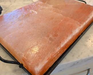 Himalayan salt block sets of this standard 12x8-inch size configuration complete with a protective metal serving frame regularly retail within this tier through premium outdoor cooking suppliers and high-end kitchenware galleries.