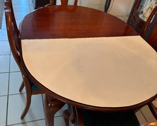 Dining room table comes with 2 leaves and the protector padding. 6 chairs, 2 with arms