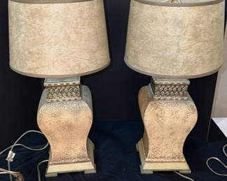 Lot 128: Pair of gold-toned textured table lamps with beige drum shades