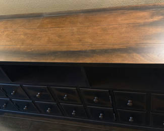 Lot 103: Dark wood console/sideboard with multiple drawers and central cabinets
