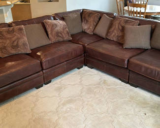 Lot 136: Brown leather Bernhardt sectional sofa with throw pillows