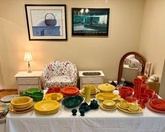 Fiesta Ware right to left Persimmon, Sunflower, Evergreen, , unsure the orange , yellows, green.  Grey left side along with cloth Fiesta Placemats and napkins.