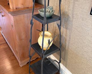 tiered metal shelf with ceramic vase and "frog" dish