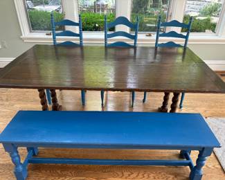 Trestle table shown with wood bench and 3 ladder-back side dining chairs