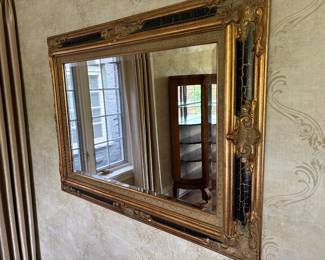 Large scale black and gold mirror with beveled edge