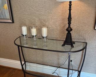  curved glass and metal two-tier Demi-lune table, lamp, and trio of candle holders