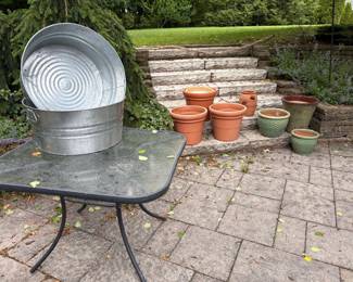 Patio glass topped table, aluminum beverage bins, ceramic and resin pots