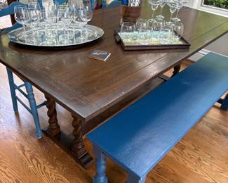 Another view of the trestle table and wood bench and trays with barware glasses
