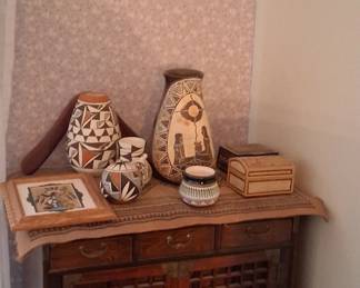 vertical antique chest with Asian sculptures.  