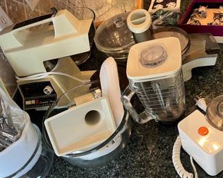 Oster Regency Kitchen Center all-in-one appliance including glass mixing bowls, stand mixer, blender, and accessories