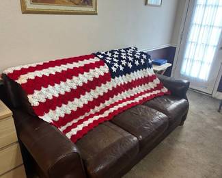 Leather couch, American flag afghan