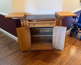 Solid oak dry bar/server cabinet with flip up serving leaves, drawer, and interior shelving