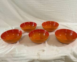 Five Orange Le Creuset Bowls
