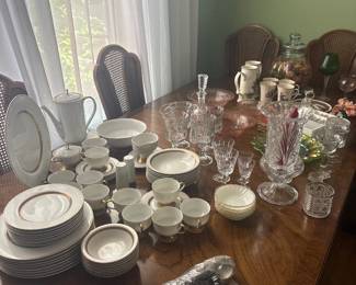 Vintage dishes and depression glass and solid wood dinning room table with chairs