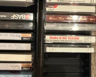 Assorted Cassette Tapes Collection with Storage Rack