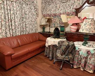 Assortment of table lamps and leather couch